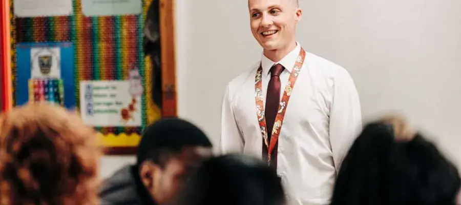 Male teacher in front of class