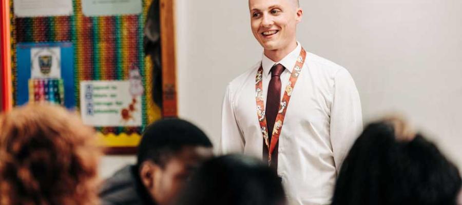 Male teacher in front of class