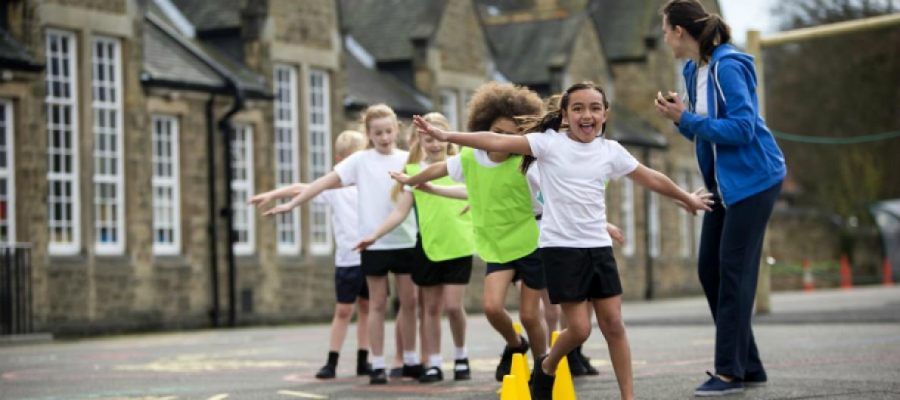 Physical education teacher with primary school students