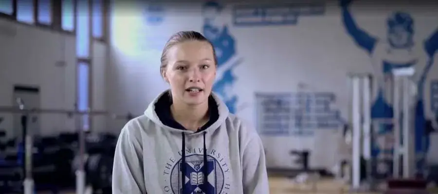Lindsay speaking in a gym