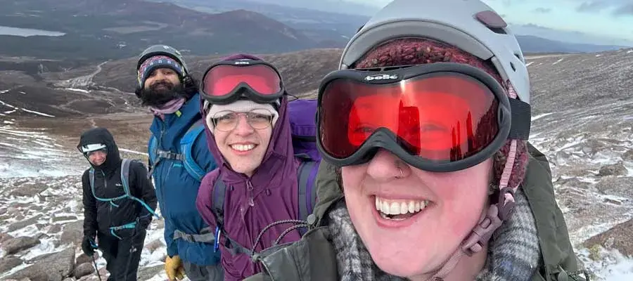 Reegan Beagley and others posing on a mountain