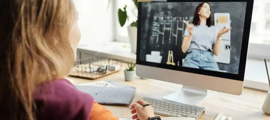 Student watching a teacher on a computer