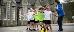 Physical education teacher with primary school students