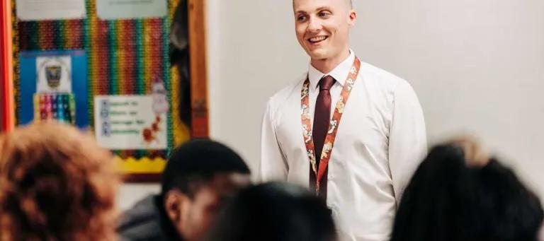Male teacher in front of class