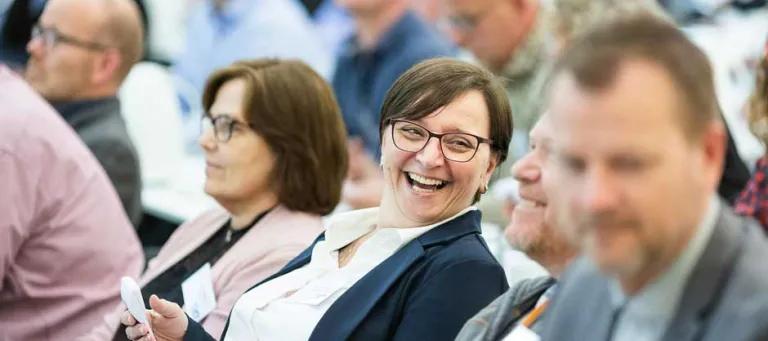 Woman in conference crowd