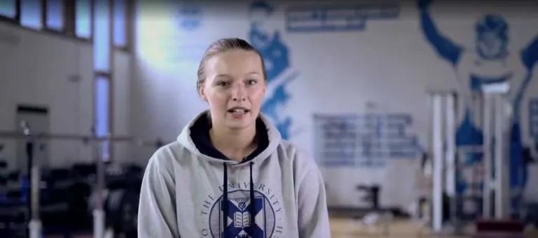 Lindsay speaking in a gym