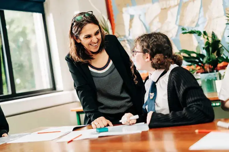 Female teacher talking to a young student