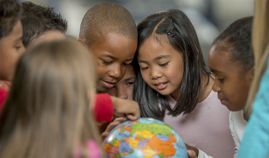 Group of children looking at a globe