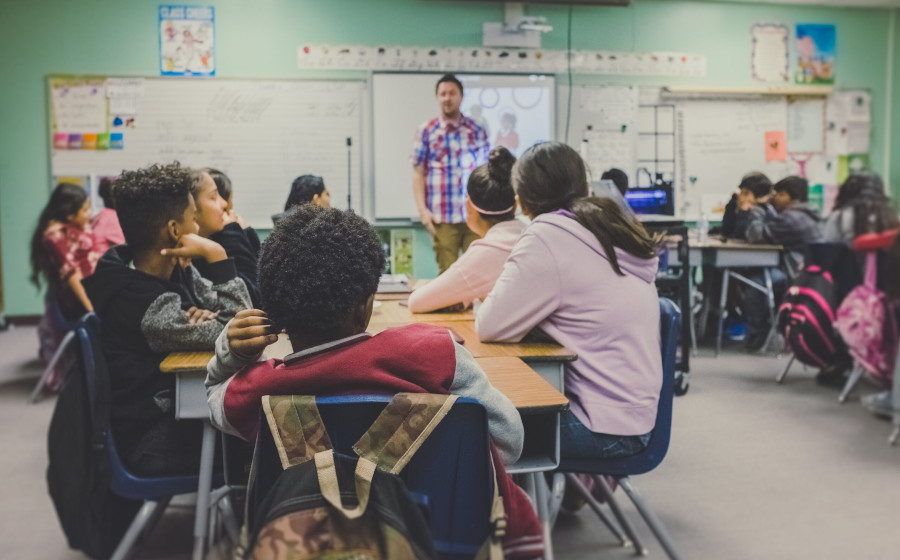 Teens listening to a teacher speak