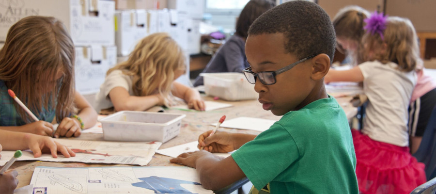 Boy doing schoolwork in class