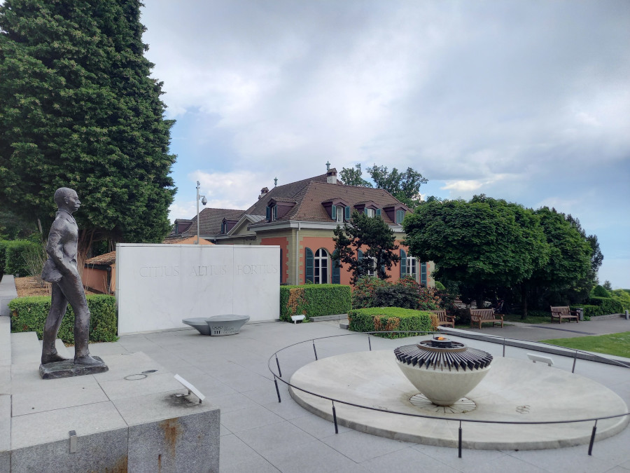 Statue of Baron Pierre de Coubertin and the Olympic Flame at the Olympic Museum